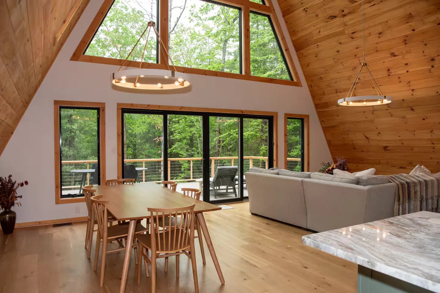 A-frame interior with vaulted ceiling and forest view