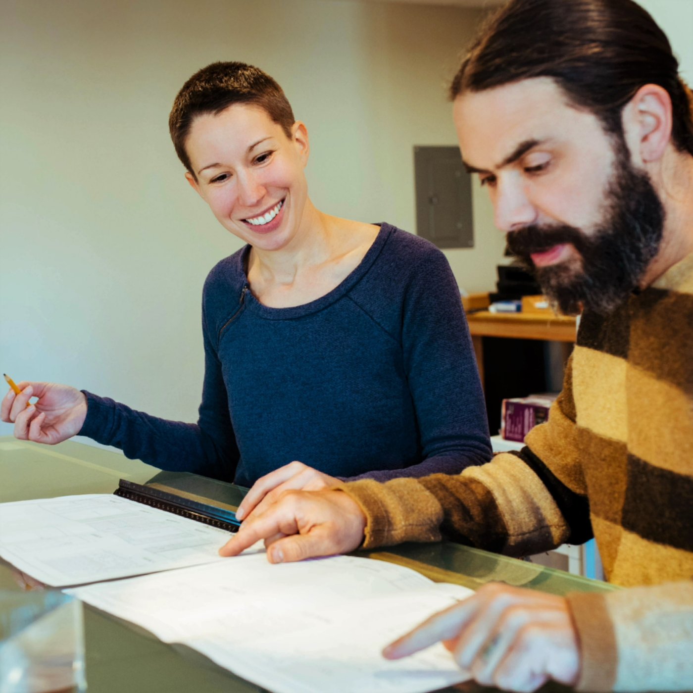 Jacob and Sarah reviewing design plans at the drafting table
